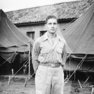 Sgt. David Axelrod, was in the 23rd Fighter Control Squadron from January to August, 1945, stationed at its headquarters at Luliang Airbase, Yunnan, China.  Here he is standing in front of the headquarters tents and building.  