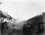 American jeeps run gauntlet of fireworks in Chinese town.