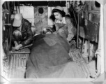 Patient loaded in the waist of a B-24 for evacuation.  Bomb-bay litter support are also used.