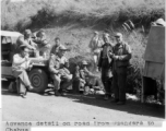 Advance detail on road from Gushkara to Chabua. American and Chinese soldiers stop for a meal over an open flame.