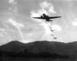 An American transport plane drops supplies by parachute somewhere in the CBI.