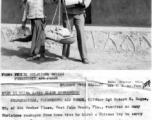 Sgt. Robert E. Hogue of Florida gets a Christmas haul of presents, a record of 13 packages. He hired a Chinese boy to help him carry them.