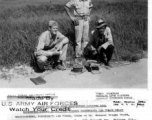 Lt. Colonel Wright Hiatt, Winchester, Indiana, and Capt. Berwyn Fry, 7314 Bennett Ave., Chicago, Ill., Engineers with the 14Th Air Force, and a Chinese worker, with two of the Japanese mines removed from the air strip, at Liuzhou (Liuchow), China.