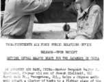 Master Sergeant Walter D. Zielinski helps a Chinese mechanic attach a cluster of bombs to a fighter plane of the CACW.