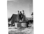 Poor man, and pumping from well at Hostel #3. China. 1944.