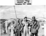 GIs visiting US military graves at Kunming. In the background are markers for the deceased, including for one of George K. Barnes, 74th Fighter Squadron, deceased July 24, 1943.  Photo from Warren C. Smith.