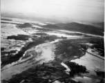 An aerial photograph during battle in the CBI. Note destroyed bridge in center of image.   (Images provided via Tony Strotman)