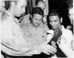 Men examine what is presumably a knife of some kind, in the CBI during WWII.