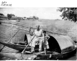 A GI in a boat with a young boat (who seems to be smoking) in Burma (or India) during WWII.  Image provided by Emery and Beth Vrana.