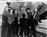 A US flyer surrounded by glamour gals stand in front of US war plane during WWII in the CBI. The plane appears to be a P-38 or F-5, with possible nickname "Sorry Beast."  Photo from Glenn W. Van Wynggarden.