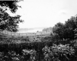 A protective wall, from the inside, with lake or river in the background. In China during WWII.