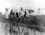 People cross field in at Misamari, India, during WWII.  Local images provided to Ex-CBI Roundup by "P. Noel" showing local people and scenes around Misamari, India.  In the CBI during WWII. 