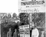 Col. Sells and two Chinese soldiers stand next to sign at the Burma-Ledo Road and Tengchong cutoff, in 1945.  Photo by T/Sgt. Syd Greenberg.