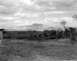 Beautiful rural scenery in Yunnan province, China, near Yangkai, during WWII, taken by Eugene Wozniak, showing an attractive tower in the plain.