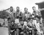 GIs pose with bottles of beer in China during WWII: "This Is A Bunch Of 396th Party Boys Enjoying A Little Brew At Luliang,China. Kneeling: Chinese man, Winter, and Walker. Standing: Gerdsen, Garver, Rush, and Tacey."