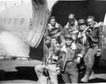 GIs lounge at the loading door of a C-47 transport plane in China during WWII during evacuation because of Ichigo: "We Were Forced To Evacuate Our Base At Kwelin, China And This Is A Pic Of Some Of The 396th Guys Loading On A C-47 To Get Out Of There. Standing: Weidenbrenner, and Reese. L/R In Plane: Souder, O'Connor, Rodriguez, and Wolfe."