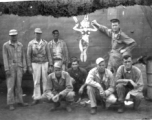 A group of GIs poses before salvaged fuselage of B-24 bomber "Lady Luck II" at Ankang, China, during WWII: "This Is A Group Of 396th Guys I Think At Ankang, China. Kneeling: O'Connor, Wander, Hanson, and Caples. Standing: Euler, Schmidt, Besson, and Tacey."