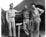 GIs in front of instrument shop tent in Liangshan, China: "Brantl, Wolfe, Hedges Taking A Break To Pose For A Picture In Front Of The Instrument Shop At Liangshan, China. Please Note The Spotless Uniforms In This Photo And All The Other Photos On This Web Site. First Class All The Way." Caption courtesy of Elmer Bukey."