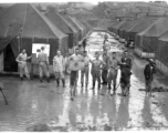 GIs and Chinese workers digging to drain the water away at a tent city of flooded living quarters at Liangshan. "This Is A Shot Of Our Gracious Living Quarters At Liangshan, China After The Creek Next To The Place Overflowed And Flooded Us Out." During WWII.