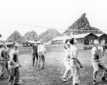 "This is some of the 396th guys playing volleyball in our hostel area at Kwelin, China. I cannot identify all of them but I do recognize "Doc" Savage...Joe Wiley...Caples, and our 1st sgt. Ed Gardner.  The unique mountain formation seen in the background of this photo was located alongside the runway at Kwelin, China and is still there to this day."