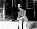 A GI typing on a small typewriter in the China during WWII.