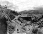 An American serviceman walking alone in the countryside in Yunnan province, China, carbine in hand. During WWII.