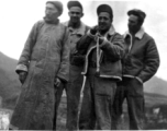 GIs pose with Chinese man and try out his long pipe. During WWII.