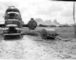 American mechanics of the 12th Air Service Group carefully ease the fuselage of a C-47 past a large concrete roller. In Guangxi, China, during WWII.