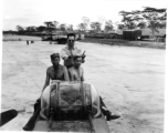 Service crew sits on fuselage of B-25 bomber during WWII.    From the collection of David Firman, 61st Air Service Group.