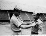 Capt. Bachrach gives and award or promotion to T/Sgt. Ingram. In Assam, India.    From the collection of David Firman, 61st Air Service Group.