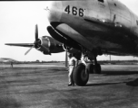 GI stands before a C-54 transport plane in the CBI.    From the collection of David Firman, 61st Air Service Group.