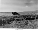 A truck with crews and mechanics zipping around Kunming base, during WWII.