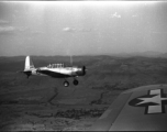 A  Vultee SNV-2 (a variant of the BT-13) trainer off the wing of another SNV-2, piloted by Charles Breingan, over China during WWII.