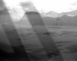 View over Dianchi Lake (滇池) outside of Kunming, China, during WWII. Small boats with sails move in a line on the water surface. 