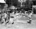 Chinese workers and Nationalist soldiers build a fortified bunker at a street corner in a town in Guangxi province, during WWII, in the summer or fall of 1944 during the Japanese push south in the Ichigo campaign.