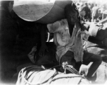 A refugee shields himself from the hot sun with a straw mat in Guangxi province, China, during WWII. Fall 1944.