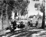 Farmers carry goods---vegetables---on shoulder poles, near Kunming, China, during WWII.