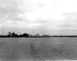 Burned building and fuel barrels at an American base, likely at Guilin, China.