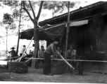 A carpenter rips lumber by hand saw in Liuzhou, China, during WWII.