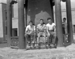 GIs of SACO and a Chinese soldier sit in front of a large cast bell, next to the Lanzhou City Hospital (兰州市立医院) in Gansu province, China, during WWII.