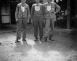 GIs with banners stuck to their chests, apparently purchased from the shop immediately behind them. In India during WWII.