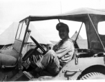 An American serviceman sits in a jeep, presumably a member of the 27th Troop Carrier Squadron, in the CBI.