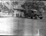 Bearers carry an American who has died from an ambulance to a temporary war-time graveyard. In the CBI, during WWII.