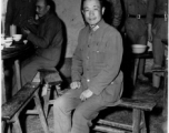 Chinese Lt. General Du Yuming, commander of Nationalist 5th Corps (第五集团军总司令兼昆明防守司令杜聿明), poses for American cameraman on bench, at rally.