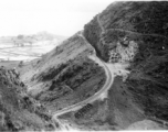 A train track--with a flipped flatcar--in Yunnan province, China. Near Camp Schiel. Yangzonghai Lake is in the background.  During WWII.