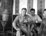 "China, Bert Krawczyk and George Clements sitting at a restaurant table with an unidentified Chinese boy." During WWII.