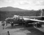 American flyers and mechs gathered around B-24 'Doodlebug' in a revetment in Sichuan, China, likely in preparation for a mission.