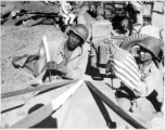 "A U.S. Army soldier and a Chinese soldier place the flag of their ally on the front of their jeep just before the first truck convoy in almost three years crossed the China border en route from Ledo, India, to Kunming, China, over the Stilwell road."