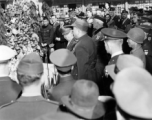 Burma Road dedication parade and ceremony in Kunming, China, on or around February 4, 1945, during WWII. Review of first convoy (or one of the first convoys) to reach China. Chinese and American military officers give speeches into microphones.