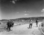 An unknown American photographer and a language interpreter take a stroll about in Yunnan, China, during WWII.